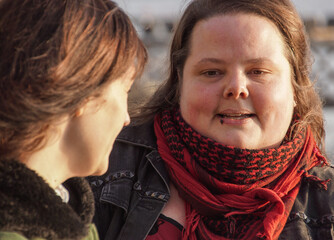 Close-up of two friends smiling outdoors