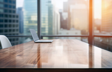 Poster - Wooden table top on laptop with blur office building background, business and technology concept. High quality photo