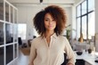© NikoG - Smiling portrait of a happy young african american woman working for a startup company in an office