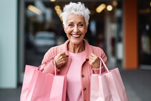 Smiling Senior Woman With Shopping Bags At Shopping Centre 