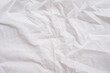 © boyloso - Full frame shot of crumpled tissue fabric texture and background. Tissue fabric is slightly rough and crisp in texture.