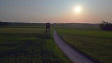 Best aerial top view flight drone austria hunting Box field road sunset Europe