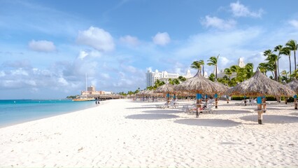 Palm Beach Aruba Caribbean, white long sandy beach with palm trees at Aruba Antilles.