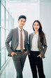 © the_lightwriter - asian businesswoman with co-worker in an office