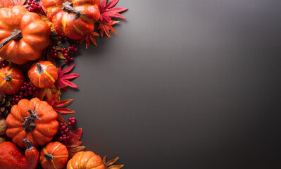 Wall Mural - thanksgiving and autumn decoration concept made from autumn leaves and pumpkin on dark background. f