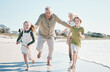 © Wesley/peopleimages.com - Running, happy and grandparents with children on beach for energy, freedom and summer vacation. Love, relax and travel adventure with family on seaside holiday for health, bonding and games together