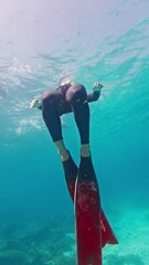 Sticker - Male freediver ascends from depth in the tropical sea