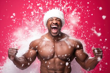 Poster - dark-skinned muscular man screaming in Santa hat with snow on pink background.