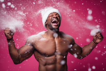 Poster - dark-skinned muscular man screaming in Santa hat with snow on pink background.