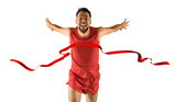 Fototapeta Sport - The runner wins by crossing the finish line ribbon on a white background