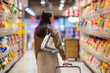 Woman go shopping in supermarket buying groceries