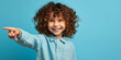 © B-Ast-BRT - a child pointing to a plain blue background, happiness, joy, fashion