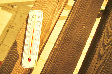 Wall Mural - Thermometer on park bench hot day.High air temperature.Sultry summer.