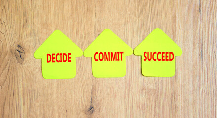 Wall Mural - Decide commit succeed symbol. Concept word Decide Commit Succeed on beautiful yellow paper house. Beautiful wooden table wooden background. Business decide commit succeed concept. Copy space.