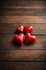 Wall Mural - Valentines day background with red hearts on wooden background