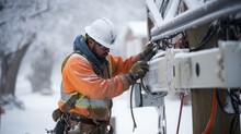 Determination Of A Manual Worker Braving The Elements To Repair An Electrical Line After A Winter Snowstorm.