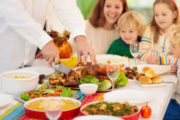 Wall Mural - Family with kids at Thanksgiving dinner. Turkey.