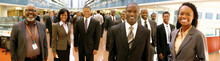 Black Businesspeople Teamwork Posing Smiling Looking At The Camera At A Business Industry Expo Convention Center Meeting. Concept Image For A International Exhibition, Conference Center, Event Fair 