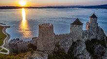 Golubac Fortress Castle Walls Standing On Danube River Bank In  Sunset Rays Aerial Panorama, Serbia