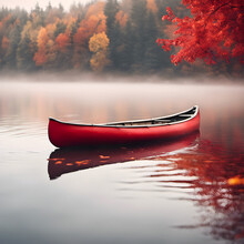 Red Canoe Floating On A Misty Lake With Autumn Foliage Reflection