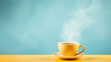 Yellow Hot Cup Of Coffee With Smoke On Pastel Blue Background, Copy Space