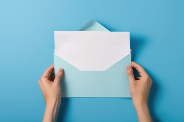 First person top view photo of female hands holding open blue envelope with white paper sheet on isolated pastel blue background with empty space, Generative AI