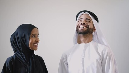 Wall Mural - Couple in love from the emirati. Woman and man with traditional dubai outfits