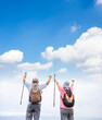 Rear view of Happy Senior couple hiking together with cloud background