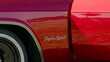 A small detail of a red car with the inscription supersport
