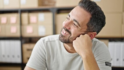 Poster - Young hispanic man ecommerce business worker sitting on table thinking at office