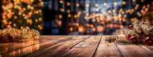 Empty Wooden Table With Christmas Decorations. Bokeh Background Of Out Of Focus Christmas Lights And A Christmas Tree. Space For Product Or Text Presentation. Web Banner Or Christmas Background.