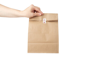 Wall Mural - take away bag in hand isolated, grocery delivery, responsible lunch packaging