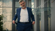 © Yuliia - Caucasian mature sad senior business man show turn empty pants pockets bankrupt no money poverty global financial crisis lack of finance employer upset entrepreneur bankruptcy debt in city outdoors