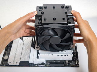 Poster - Installing a large air cooler on a computer processor.