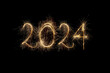 Happy New Year 2024. Number 2024 written sparkling sparklers isolated on black background with copy space for text. Glowing, creative overlay template for holiday greeting card