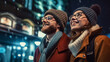 young Couple in warm clothes and eyeglasses smiling while looking up at lanterns and admiring London city street at night.