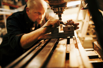 Wall Mural - Middle aged man working in a factory