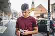 © Miljan Živković - portrait of teenager man stand in front of bank ATM hold credit card