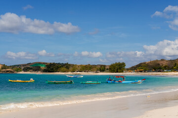 The most beautiful beach in Lombok and the closest to Kuta is Tanjung Aan Beach, A Hidden Gem Waiting for You to Explore on Lombok. beautiful beach surrounded by hills and blue sea