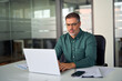 © insta_photos - Busy middle aged professional business man executive investor using computer working at desk. Male manager expert looking at laptop thinking on online finance market analysis, elearning in office.