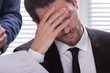 © Andrey Popov - Stressed Businessman Sitting In Office