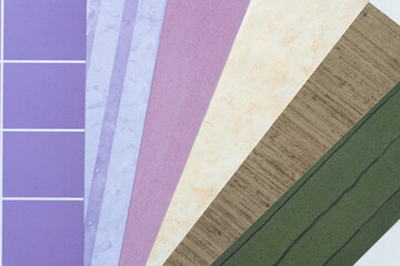 Wall Mural - paper background featuring an array of scrapbooking paper samples from purple to green