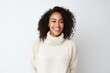 Portrait photography of a Colombian woman in her 30s wearing a cozy sweater against a white background