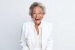 Portrait photography of a cheerful Colombian woman in her 90s wearing a sleek suit against a white background