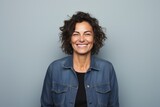 Fototapeta Do akwarium - Close-up portrait photography of a Italian woman in her 40s wearing a denim jacket against a minimalist or empty room background