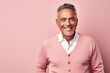 © Anne Schaum - Medium shot portrait photography of a Colombian man in his 60s against a pastel or soft colors background