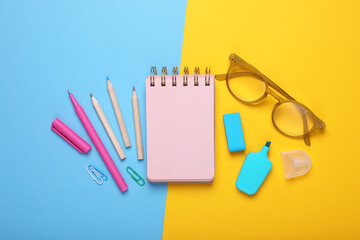 Poster - Flat lay composition with pink notebook and other school stationery on color background, space for text. Back to school