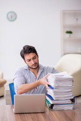 Wall Mural - Young male employee and too much work in the office