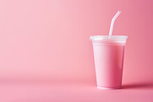 Pink drink in plastic cup isolated on pink background. Take away drinks concept with copy space