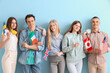 © Pixel-Shot - Group of students with flags of different countries on blue background